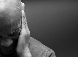 deafness suffering from hearing loss on grey black background with people stock image stock photo	
