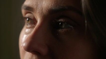 Portrait of attractive female model in negative mood. Extreme close up shot of woman face part in...