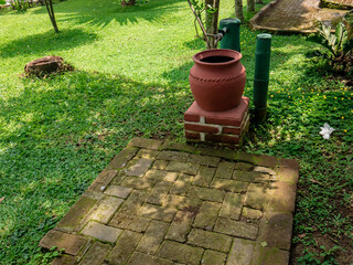 traditional water barrel placed in the garden

