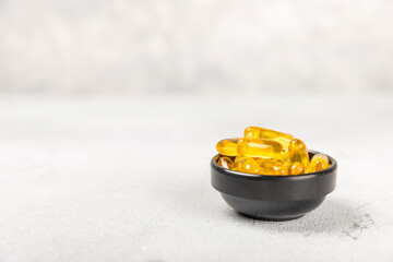 Omega-3 capsules on a white texture background. Fish oil, tablets, capsules and vitamins, food...