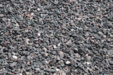 Gray granite stone. Material for construction. Texture of gray and white rocks. Aggregate for construction of buildings, homes, streets, urban areas, landscaping.