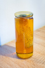 Jar of honey that also contains a honeycomb, sold in health food stores