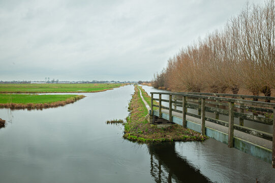 Footbridge in the Dutch landscape leading to Polder Bloemendaal between Gouda and Waddinxveen, The Netherlands