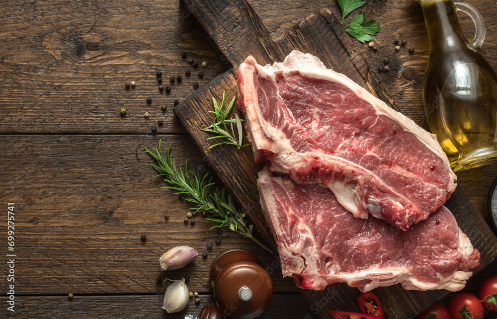 Poster two raw beef steak on wooden board on wood table with copy space top view