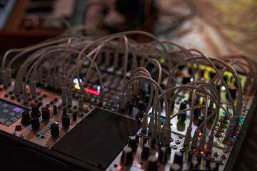 Close up shot of portable operating sound mixer board with numerous wires prepared for studio recording