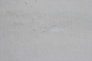 Shabby white wall with cracks