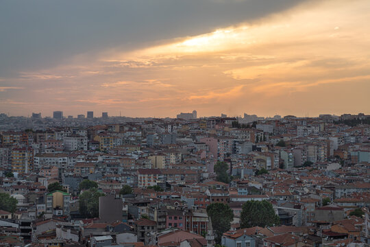 A bright yellow sunset over the Istanbul (Beyoglu district) panorama in the evening. Wide endless housing above sundown skies.