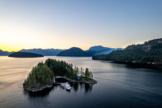 Skookumchuck Narrows with Sechelt Inlet in the Background. Sunshine Coast, British Columbia, Canada, during a pristine sunset. Aerial picture of the wild scenery. Private residential island yacht. 