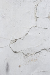 Shabby white wall with cracks
