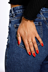 ed oval-shaped manicure, female hands with manicure, hand in the pocket of  blue jeans