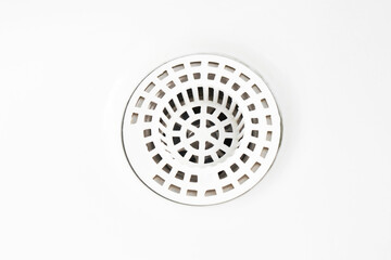 White ceramic bathroom sink. Plastic white sieve closeup. Empty copy space background. Round shape strainer.