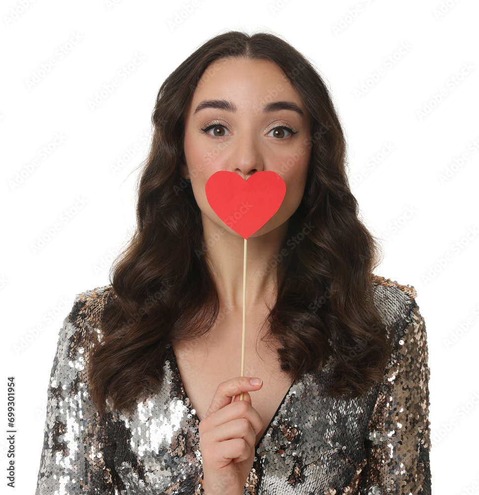 Wall mural Beautiful young woman covering her mouth with paper heart isolated on white