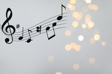 Music notes on blurred background, bokeh effect