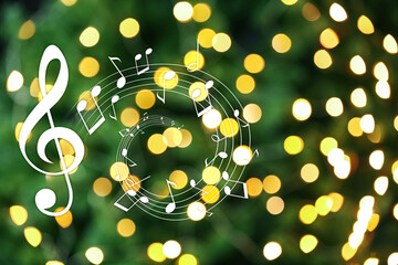 Music notes on blurred background, bokeh effect. Christmas and New Year melody