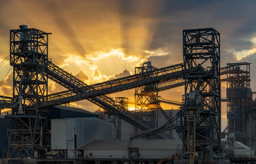 Dramatic sunset over the machinery of loading dock at Port Allen by the Mississippi river in Baton Rouge Louisiana