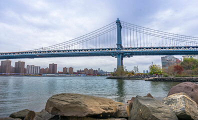 Panorama of Manhattan Bridge and panoramic view of downtown Manhattan at cloudy day in New York...