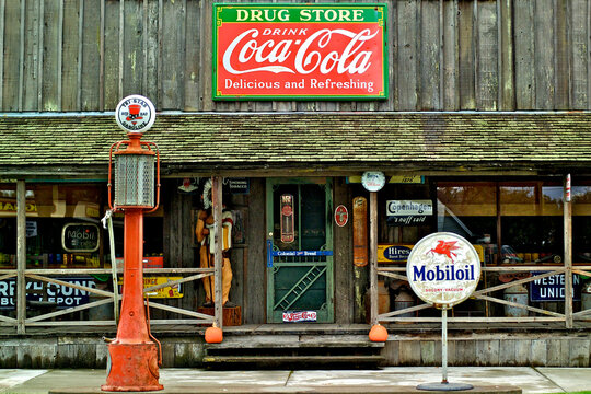 Old petroliana and soft drink signage from bygone era 