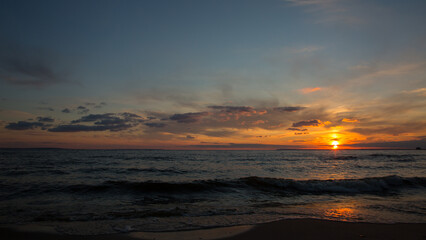 Fototapeta na wymiar Orange sunset on the sea, dramatic sunset