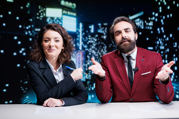 Newscasters team debating live topics on tv channel, broadcasting night show worldwide and...