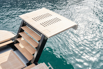 Stern of luxury motor boat with stairs on famous yacht show, exhibition of luxury mega yachts, the...