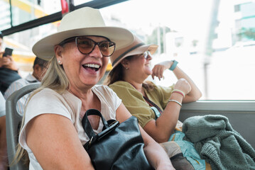 Tourists travel happy on the bus.
