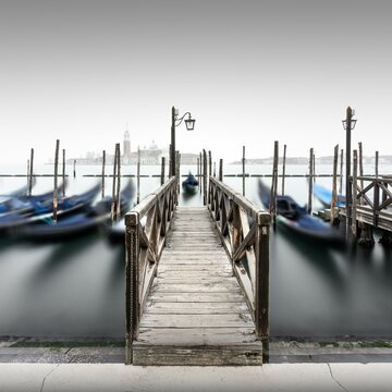 Minimalist long exposure of the gondolas at the Piazzetta near the Campanile at St. Mark's Square in Venice, Italy, Europe