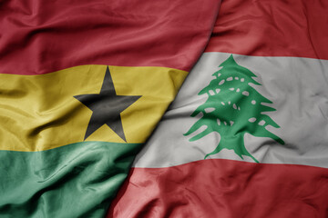 big waving national colorful flag of lebanon and national flag of ghana .