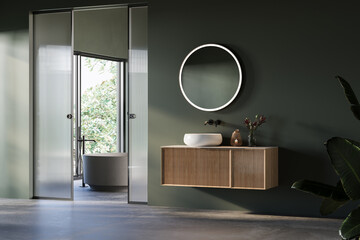 Modern bathroom interior with concrete floor, green and gray walls, vanity white sink, oval mirror,...