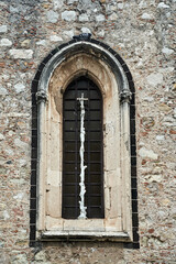 Window of a medieval stone church in Taormina on the island of Sicily