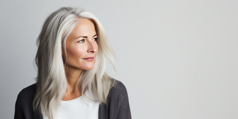 Middle aged woman with beautiful white hair, copy space - obrazy, fototapety, plakaty