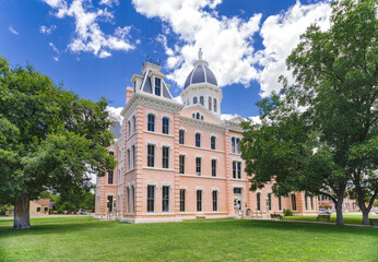 The pink colored Empire Style architecture Presidio County Courthouse in Marfa, Texas has been...