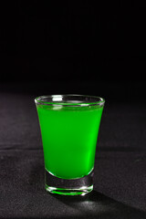 refreshing alcoholic drink with berries, ice vodka and gin, lemon peel served in glass cup on the counter on blurred background