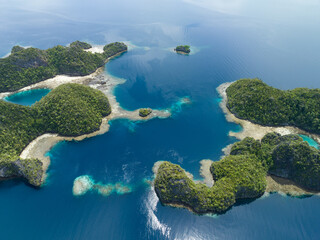 Limestone islands rise from the impressive seascape in Misool, Raja Ampat, Indonesia. These scenic...