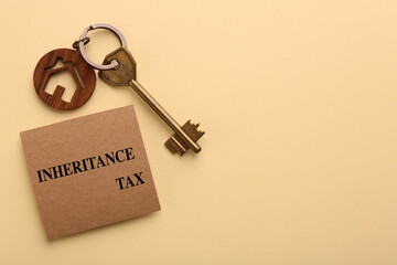 Inheritance Tax. Card and key with key chain in shape of house on beige background, top view. Space for text