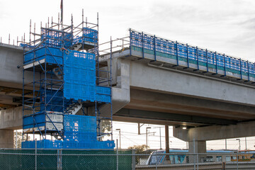 Rail bridge under construction with a train underneath. Pakenham Victoria Australia