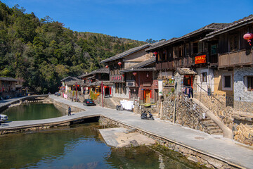 The cars parked at one of the Tulou buildings, Blue sly, copy space for text