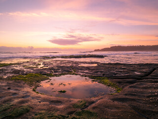 Fototapeta na wymiar sunrise over the sea with cloud reflections