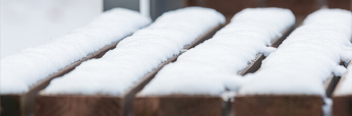 Snow piled up on the park bench.