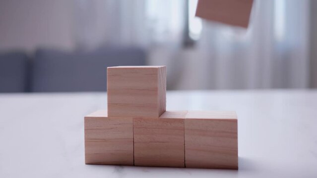 Growth reduction process concept - Detail of hand removing blocks from pyramid