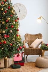 Interior of living room with glowing Christmas tree, armchair and lamp
