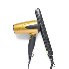 Hair dryer and straightening iron on white background