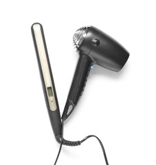 Hair dryer and straightening iron on white background