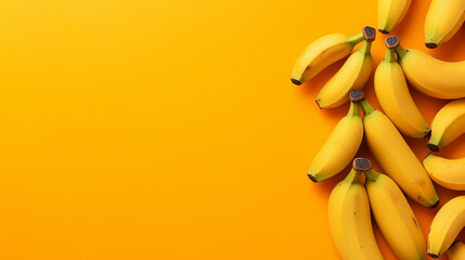 yellow paper bananas on orange with copy space