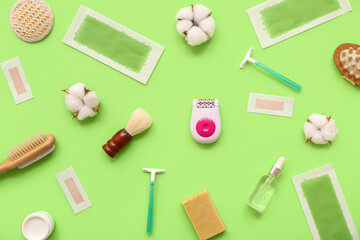 Different supplies for hair removal with cosmetic oil on green background