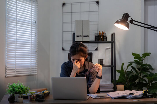 Business Woman Asian In Office, Tired Or Fatigue While Working Late At Night On Laptop Computer. Burnout, Migraine And Female Person With Depression, Anxiety Or Brain Fog, Stress And Deadline