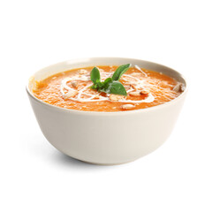Bowl of delicious pumpkin cream soup with basil and seeds on white background