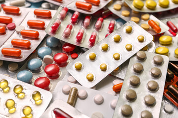 Blister packs with different pills as background