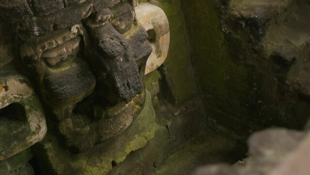 Slow pan on ancient stone carving in Tikal National Park