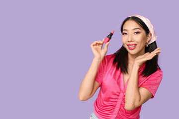 Beautiful Asian woman with lipstick on lilac background