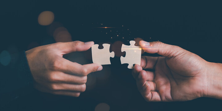 Businessman holding a puzzle piece to find a business solution ,Connecting success and problem solution from creativity ,strategic planning to develop organization into future ,leadership strategies